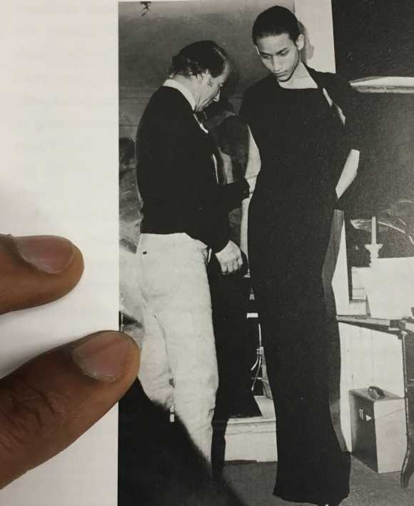 Jimmy Robert, 2018, research still, Charles James adjusting a black crepe gown on Juan Fernandez, photo by Bill Cunningham in Douglas Crimp, Before Pictures, 2016