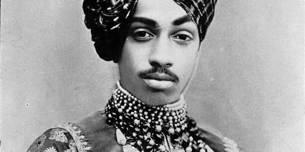 This portrait of Maharaja Sardar Singh was probably made in Jodhpur around 1900. Born in 1880, Sardar succeeded his father Jaswant Singh in 1895, at the age of 15, as Maharaja of Jodhpur. In the photo, Sardar is wearing the court dress and precious jewelry that pertains to his position as Maharaja. The turban alone is a badge of honor and a status symbol. More striking, however, is the ornament, the 'shast', that has been applied to it. It consists of a painted portrait of Sadar's father, set entirely in gold and trimmed with pearls. This tradition dates back to the Mughal period and only the most eminent were granted the privilege of wearing the portrait of the Maharaja. By wearing this 'shast' Sadar expresses, very consciously, both his strong sense of belonging to - and respect for - the memory of Jaswant Singh. His father died in 1895. But not only through the miniature portrait is Sardar connected with his father. The necklaces of rows of pearls and (uncut) diamonds, together called 'kantho', were also worn by Jaswant Singh on important occasions and recorded on the painted portraits known of him. The portrait thus contains many clues through which the person portrayed expresses his connection with the royal line of Jodhpur. Maharaja Sardar Singh ruled until his death in 1911 after which the regalia passed to his first son, Sumer Singh. We add this image to this conversation to discuss the attempts to curate differently and to question how we care for images and objects that are embedded in the pasts and structures that we aim to address through the attempts of curating and collecting differently.