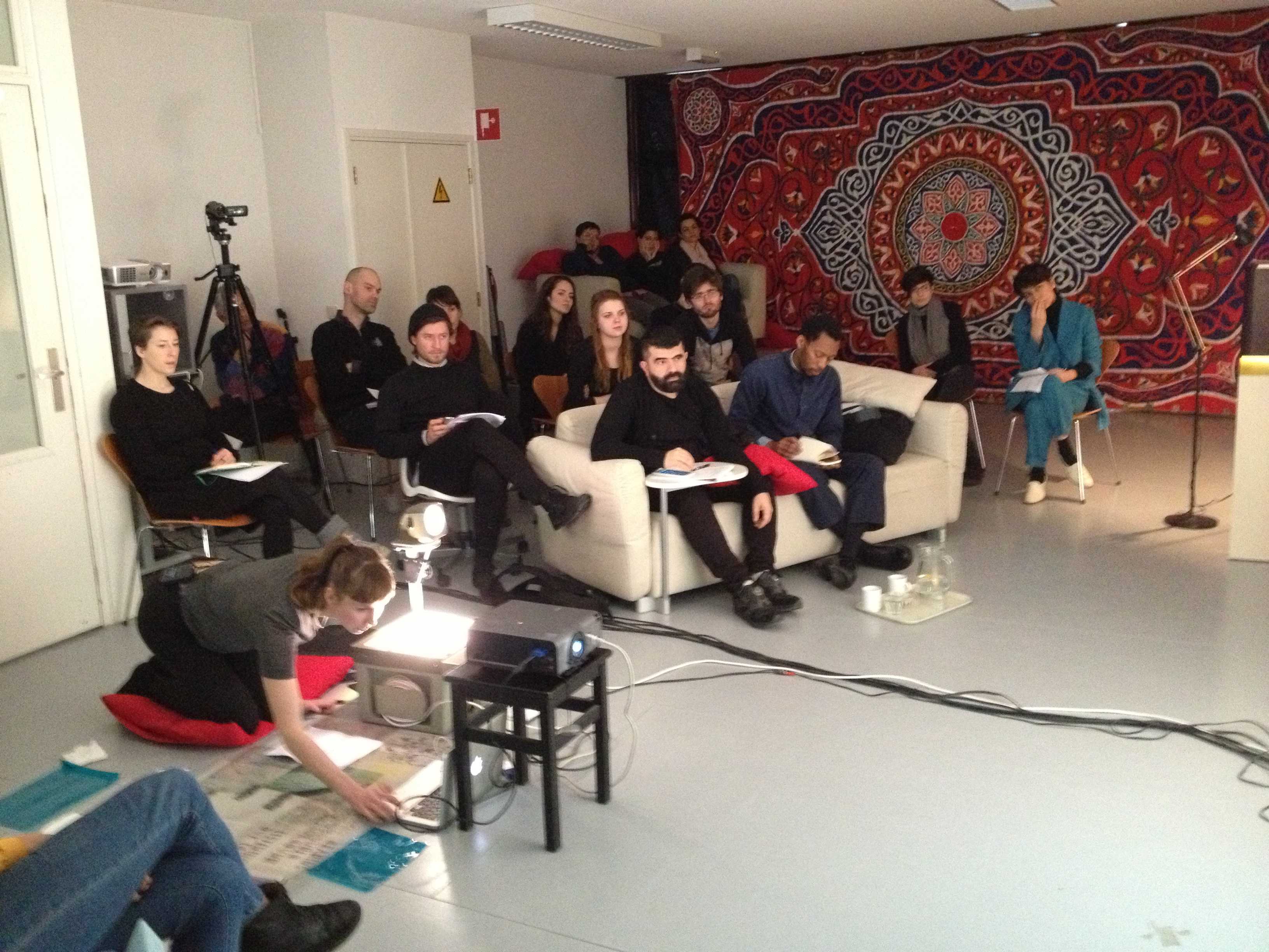  Lecture-performance Bryony Gillard, 2015. Respondents (on the white couch): Christian Nyampeta (right)and Mohammad Salemy (left), in the background Snejanka Mihaylova (wearing a blue suit).
