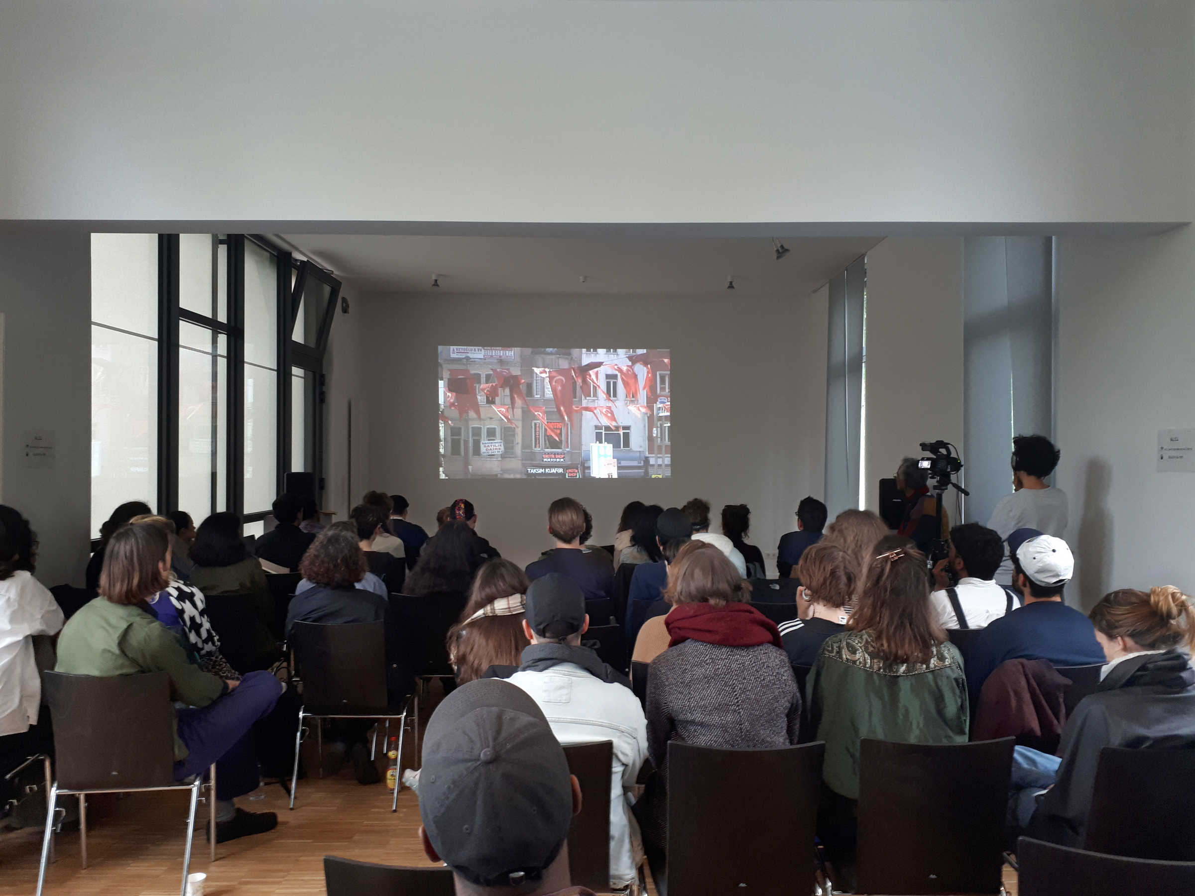 Özgür Top presenting his latest video work on Final Kitchen presentations, Silent Green, Berlin