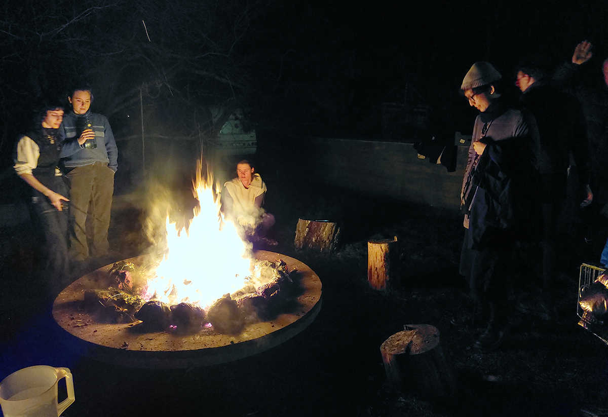 Participants of COOP study group - UNRAVELING THE (UNDER-)DEVELOPMENT COMPLEX on an open fire cooking workshop with chefs Jonas Palekas & Gabija Balčiūnaitė. NAC (Nida Art Colony), Nida. January 2023. Photo credit: Nikos Doulos.