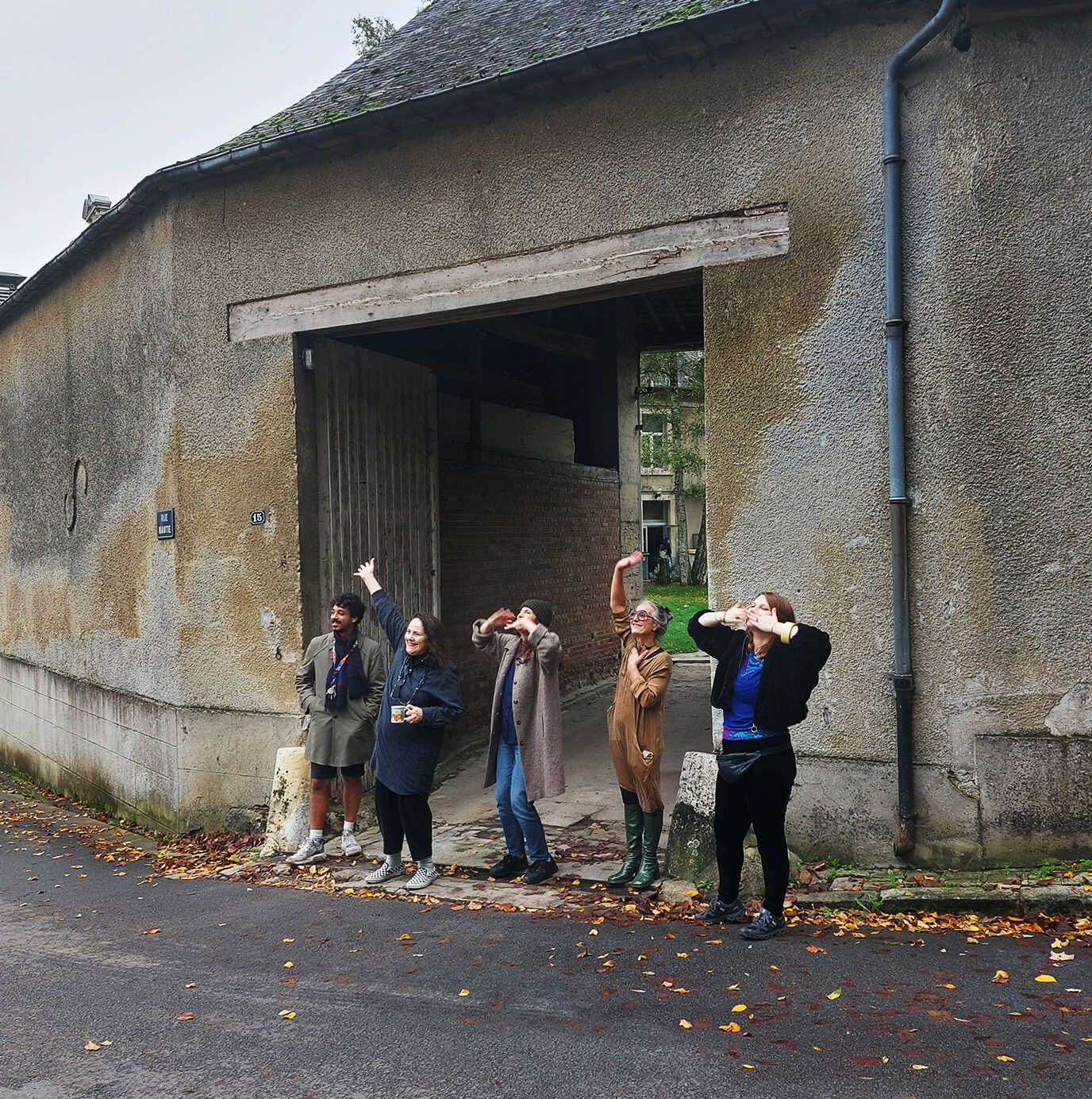 DAI crew Gabriëlle Schleijpen, Kastė Šeškevičiūtė and Jacq van der Spek, with Lucas Lugarinho Braga (DAI, 2023) and Suzz, assistant to our chef, all weaving goodbye to students departing PAF. October 2023. Photo credit: Nikos Doulos.