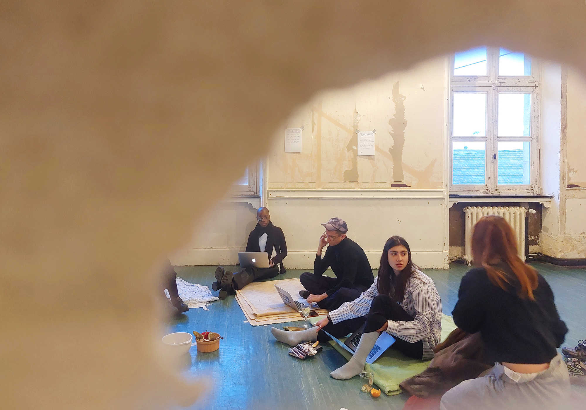 COOP Study group: Publishing Practices convening at PAF's Yoga room ~ observed through the paper cuts of the door window. PAF (St.Erme), March 2023. Photo credit: Nikos Doulos