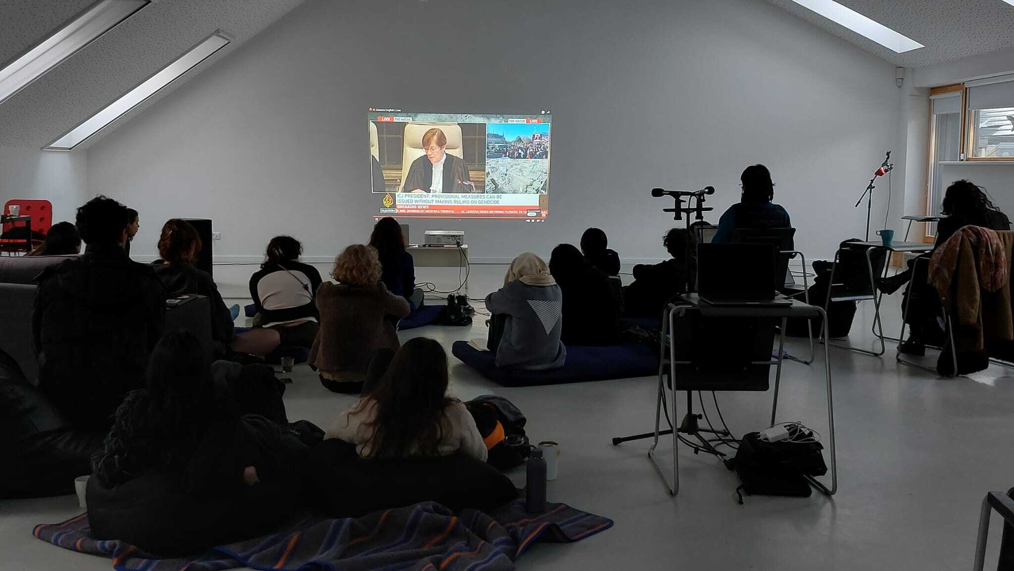 January 26, 2024 ~ DAI-students watch the streaming of the  ICJ rulling during DAI Confluence 2 in Nida, Lithuania. 